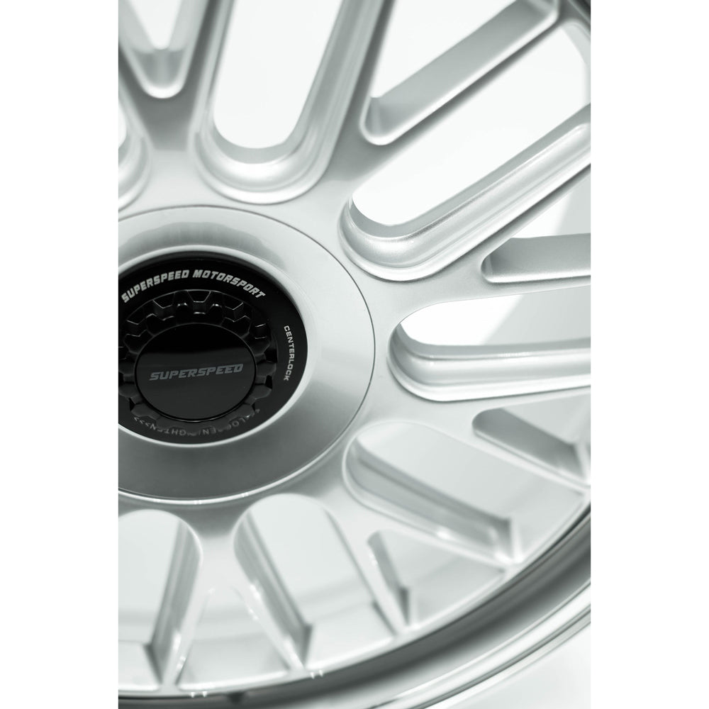 Close-up of a silver alloy wheel with 'Superspeed Motorsport' branding.