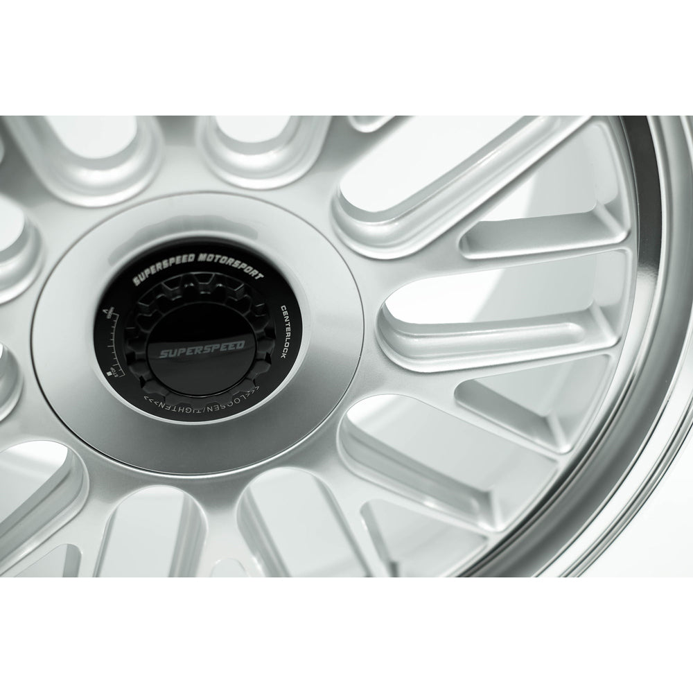 Close-up of a silver alloy wheel with 'SuperSpeed Motorsport' branding.