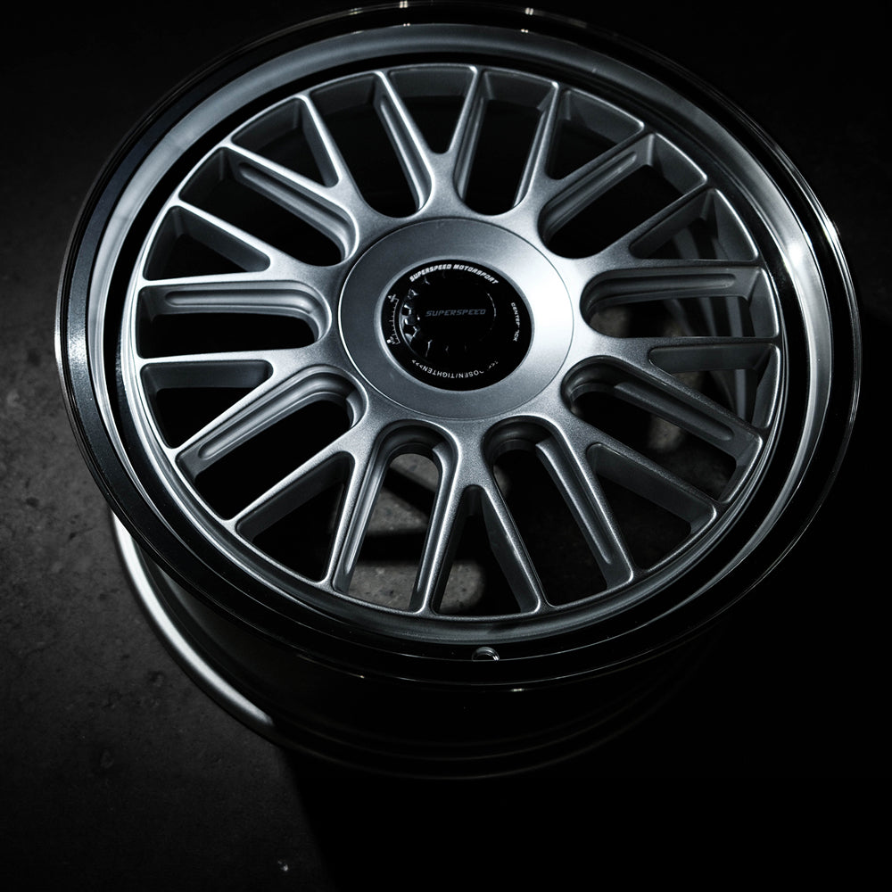 Close-up of a car wheel rim with a dark background